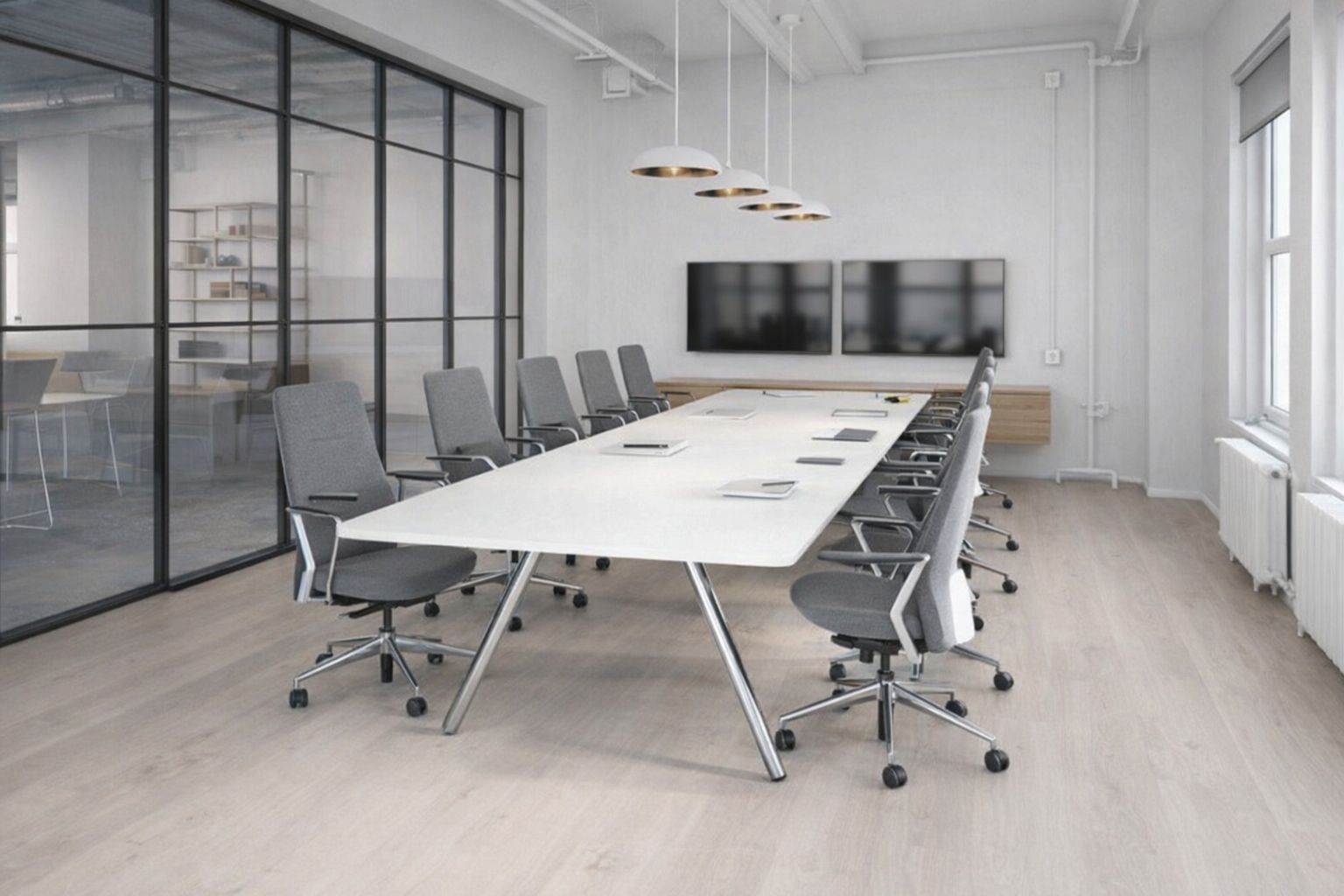Modernt och ljust mötesrum på Östermalm med långt vitt bord och grå stolar.