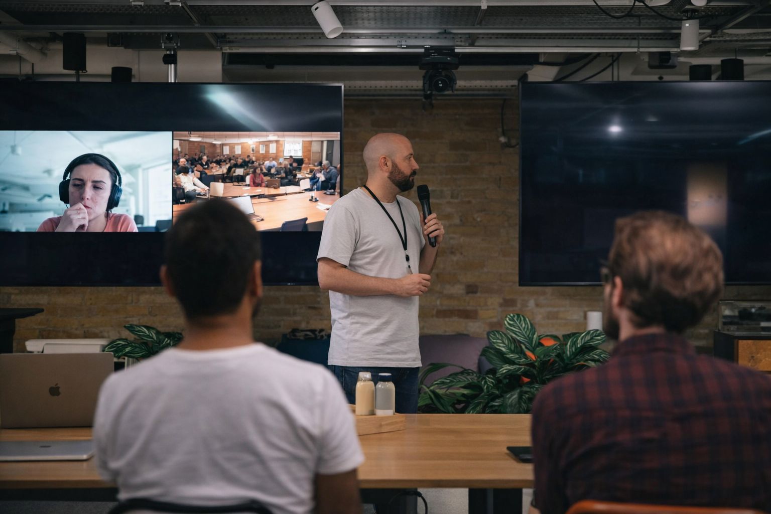 En presentatör håller ett hybridmöte i ett modernt mötesrum.